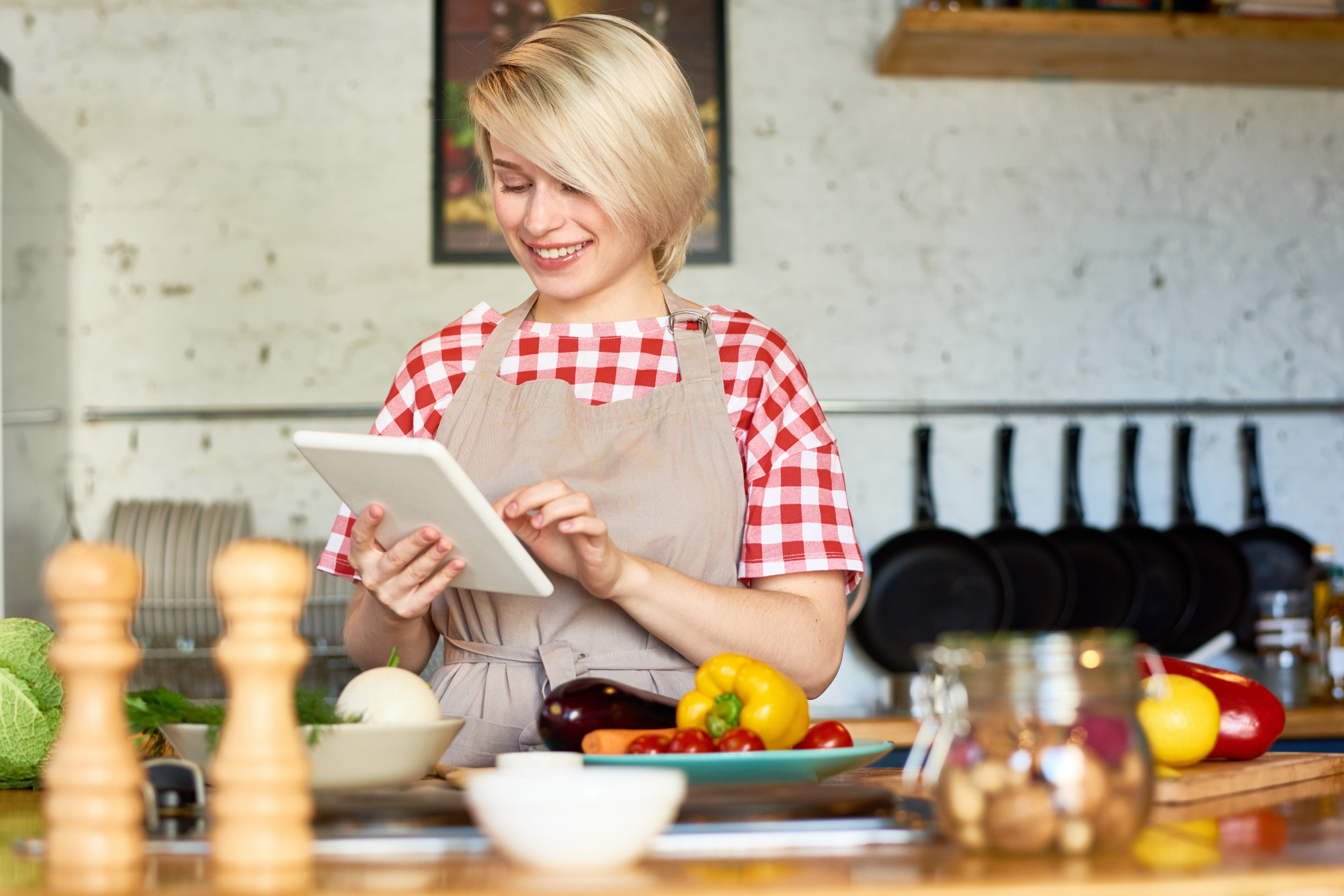 Busy home cook looking at a recipe on a tablet